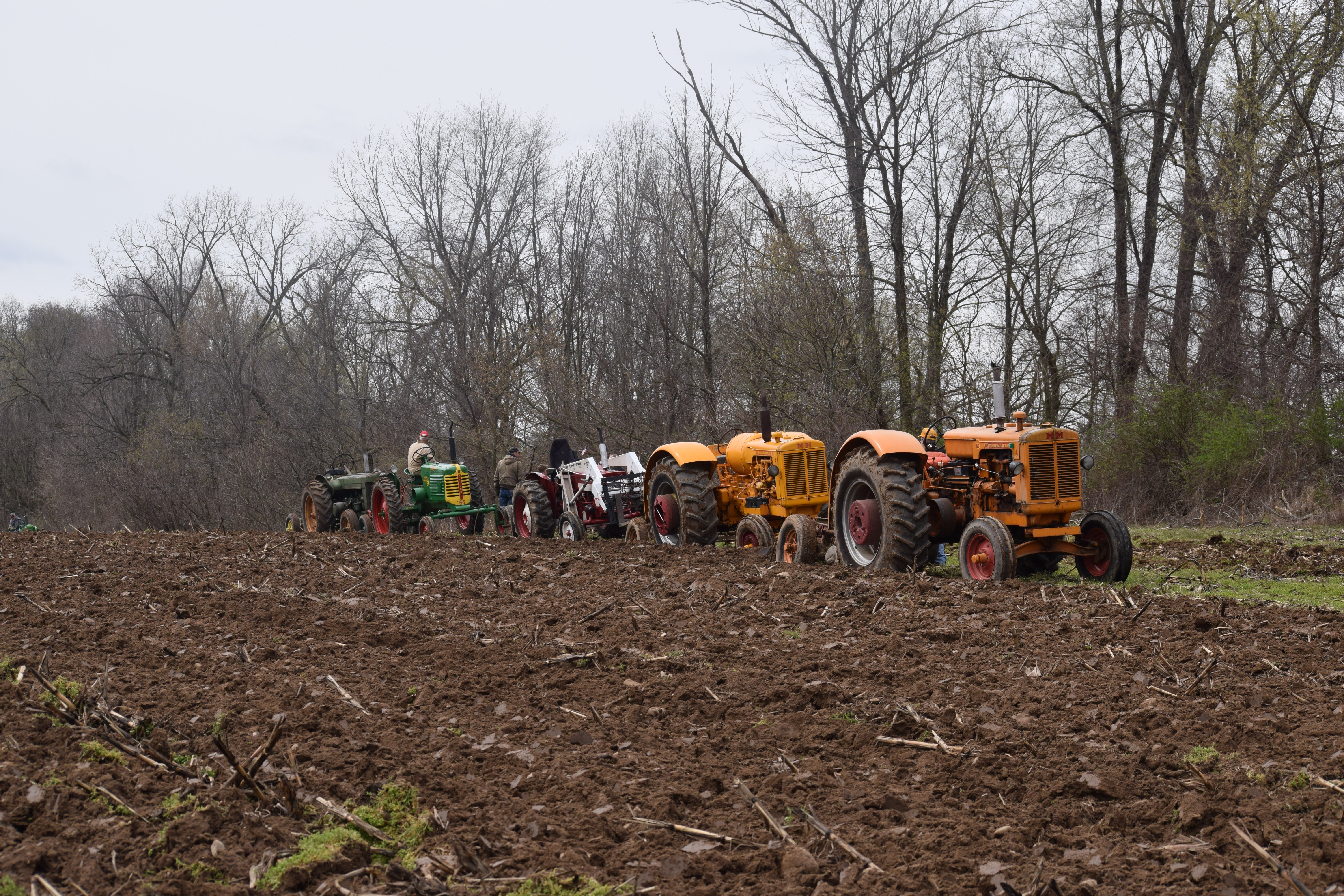 Multiple tractors plowing